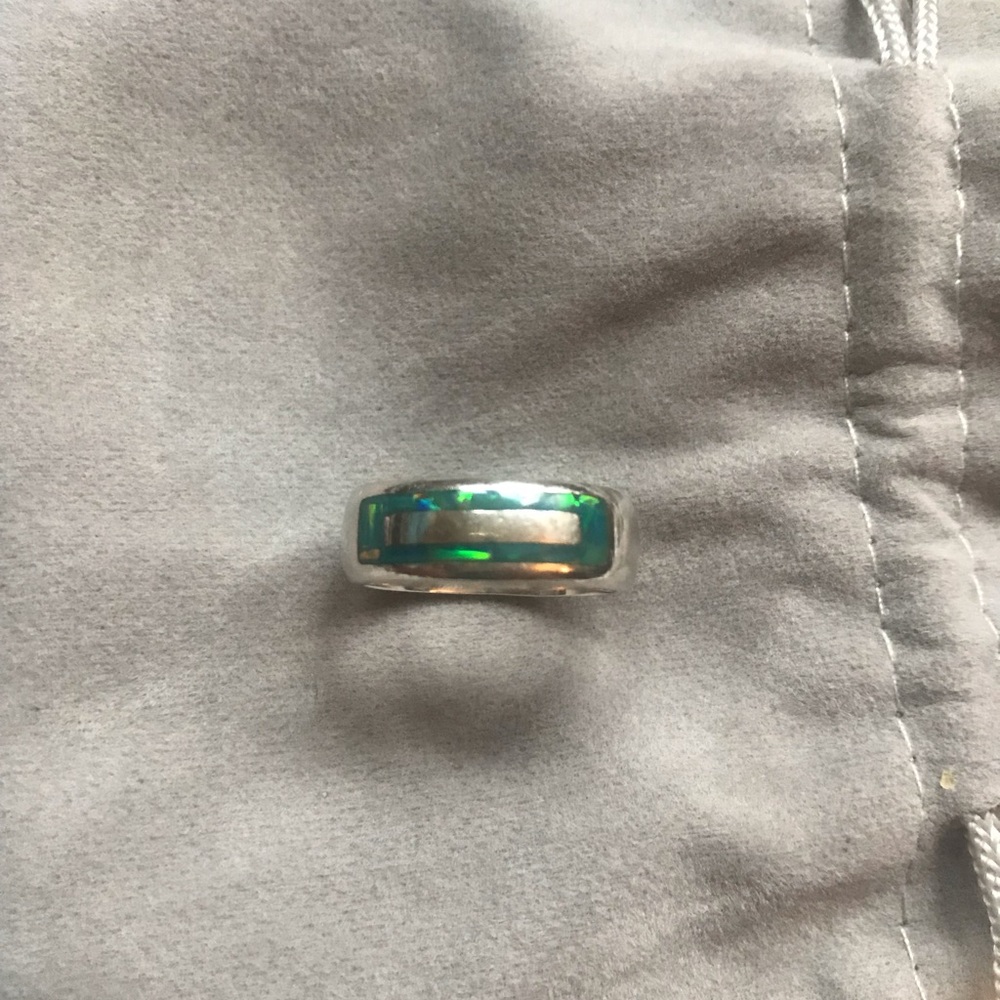 Beautiful silver band ring with embedded gems.